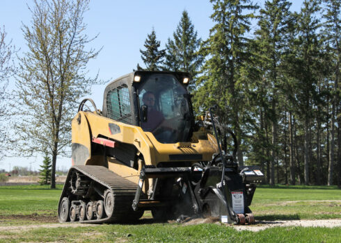 cat skid steer pulling pavement saw right view